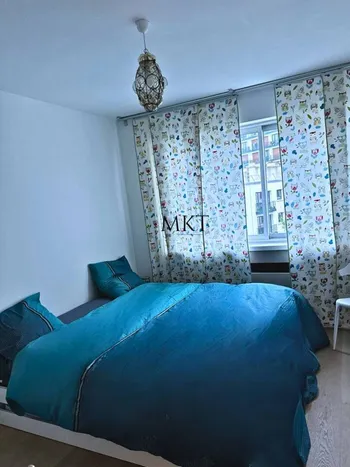 Blue bedroom with patterned curtains
