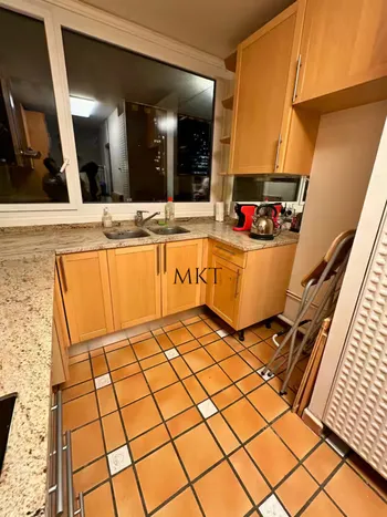 Kitchen with terracotta tiles and wooden cabinets