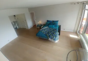 Blue bedroom with leaf-patterned bedspread