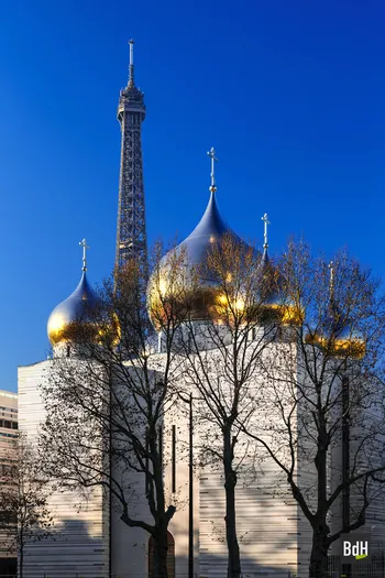 Eiffel tower behind golden domes at dusk